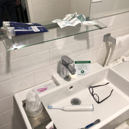 Updated bathroom clean and nice but the glass shelf tilts and everything falls in the sink.