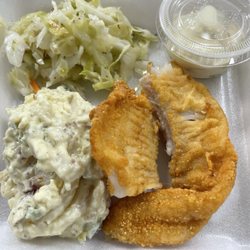 Fried cod with potato salad, cole slaw sides.