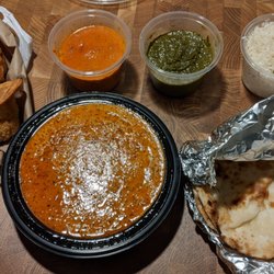 New Novelty Restaurant & Sweets - Full order of lamb curry, veggie samosas, and a dinner take out special (butter chicken, palak paneer, naan, and rice)