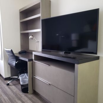 Hyatt House Carlsbad - Nice big television screen, desk, lounge area, work station in lobby, desk in room. - Hotels Near Me - Carlsbad, New Mexico