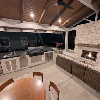 Arreola Landscape and Pool Design - Outdoor kitchen with concrete counter tops and fireplace - Landscaping Near Me