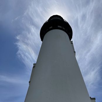 Yaquina Head Lighthouse - Closeup with the sun over the top of the tower - Landmarks & Historical Buildings Near Me - Newport, Oregon Yaquina Head Lighthouse - Closeup with the sun over the top of the tower - Landmarks & Historical Buildings Near Me - Newport, Oregon