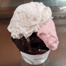 This is an overhead view of Giolitti's deliciousness: the peach flavor (the 3rd) is hidden and the white topping is whip. This is an overhead view of Giolitti's deliciousness: the peach flavor (the 3rd) is hidden and the white topping is whip.