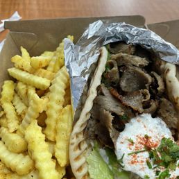 This gyro is piled high with meat. This gyro is piled high with meat.
