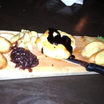 The Blake House - This poorly lit picture doesn't do this dish justice! Baked Brie with red onion marmalade, roasted garlic, & red grape reduction - Pubs Near Me - Toronto, Ontario