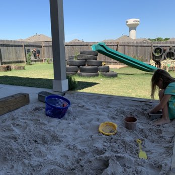 Happy Roots Learning Center - Our sand pit looking into tie playground - Child Care & Day Care Near Me - Buda, Texas