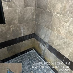 Lime scale on walls and floor of shower.  Clean it up Management.