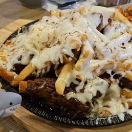 Kalbi jjim (short ribs with some vegetables, rice cakes and fries, doused in sauce and cheese). Enough for 4 people! Kalbi jjim (short ribs with some vegetables, rice cakes and fries, doused in sauce and cheese). Enough for 4 people!