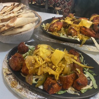 Himalayan Restaurant - Garlic naan, lamb sasuwa (front) tandoori chicken (back) - Indian Near Me - Big Bear Lake, California