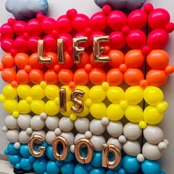 Balloon wall with "Life Is Good" message for alumni celebration at the Proton Treatment Center in Baltimore, MD. A cheerful welcome display.