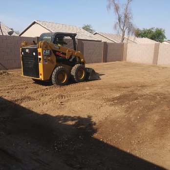 Reza Landscaping - a small construction vehicle in a yard - Landscaping Near Me Reza Landscaping - a small construction vehicle in a yard - Landscaping Near Me