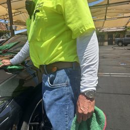 Employees wearing metal watches and metal bracelets while drying cars