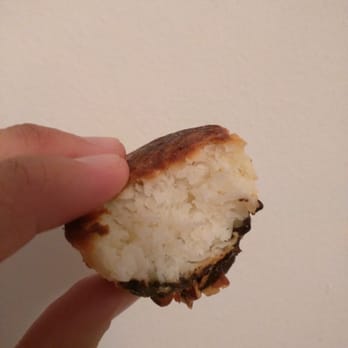 Danny Macaroons - a hand holding a half eaten macaroon - Macarons Near Me - New York, New York