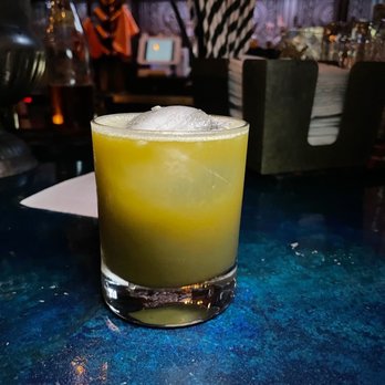 The Blind Elephant - Cabrini-Green: matcha, lavender bitters, vodka, lillet blanc. Garnished with lavender flowers - Lounges Near Me - Wilmington, North Carolina The Blind Elephant - Cabrini-Green: matcha, lavender bitters, vodka, lillet blanc. Garnished with lavender flowers - Lounges Near Me - Wilmington, North Carolina