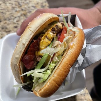 California Burger - a hand holding a sandwich - Burgers Near Me - Indianapolis, Indiana California Burger - a hand holding a sandwich - Burgers Near Me - Indianapolis, Indiana