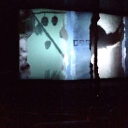 Moderate-sized movie theater with comfortable pleather seating.