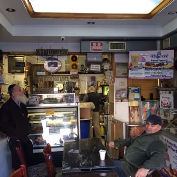Think Sweet - a man sitting at a table in a restaurant - Delis Near Me - Brooklyn, New York