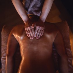 Cuyahoga Massage Therapy - Releasing tension between shoulders with broad pressure