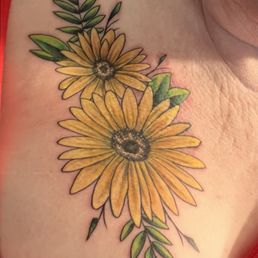 Daisy tattoo in upper right chest Daisy tattoo in upper right chest