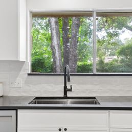 Sleek black quartz countertops with new sink and faucet Sleek black quartz countertops with new sink and faucet