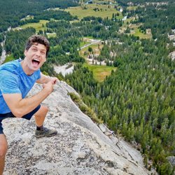 Lembert Dome/Young Lakes Trail - Rock climber below wearing a red hat.
