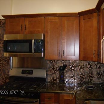 3rd Generation Design & Construction - a kitchen with stainless steel appliances - Glass & Mirrors Near Me