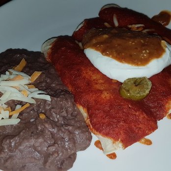 Las Palapas Resort Grill - Chilied Pork Enchilidas with refried beans - Latin American Near Me - Saskatoon, Saskatchewan