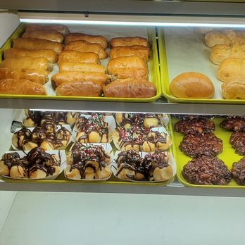 Honey Donuts - a display case filled with various types of donuts - Breakfast & Brunch Near Me - Odessa, Texas