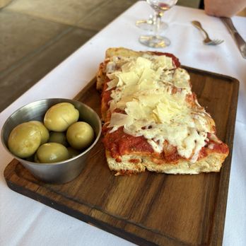 Grappolo Cucina Italiana - Olives and bread that looks like Chicago pizza - Italian Near Me - Winter Park, Florida Grappolo Cucina Italiana - Olives and bread that looks like Chicago pizza - Italian Near Me - Winter Park, Florida