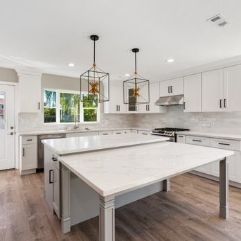 IMD Home Design - a kitchen with white cabinets and a large island - General Contractors Near Me - Anaheim, California IMD Home Design - a kitchen with white cabinets and a large island - General Contractors Near Me - Anaheim, California