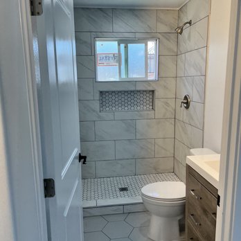 OP Construction - a bathroom with a toilet and shower - General Contractors Near Me