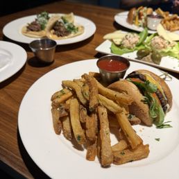 Short rib Tacos, salmon lettuce wraps, and cheeseburger and fries split