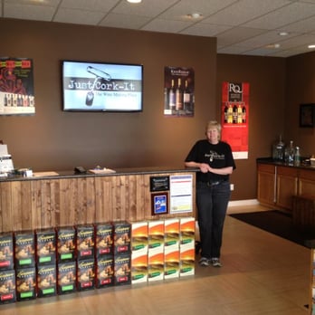 Just Cork-It - Tecumseh - a woman standing in front of a counter in a store - Wineries Near Me - Tecumseh, Ontario Just Cork-It - Tecumseh - a woman standing in front of a counter in a store - Wineries Near Me - Tecumseh, Ontario