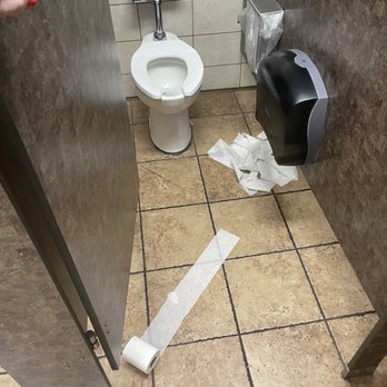 Kroger - a toilet with a roll of toilet paper on the floor - Grocery Near Me - Bossier City, Louisiana