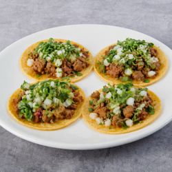 Fuego Cravings - Street tacos loaded with fresh cilantro, onions, savory meat, and our signature guacamole sauce  Fresh off the grill