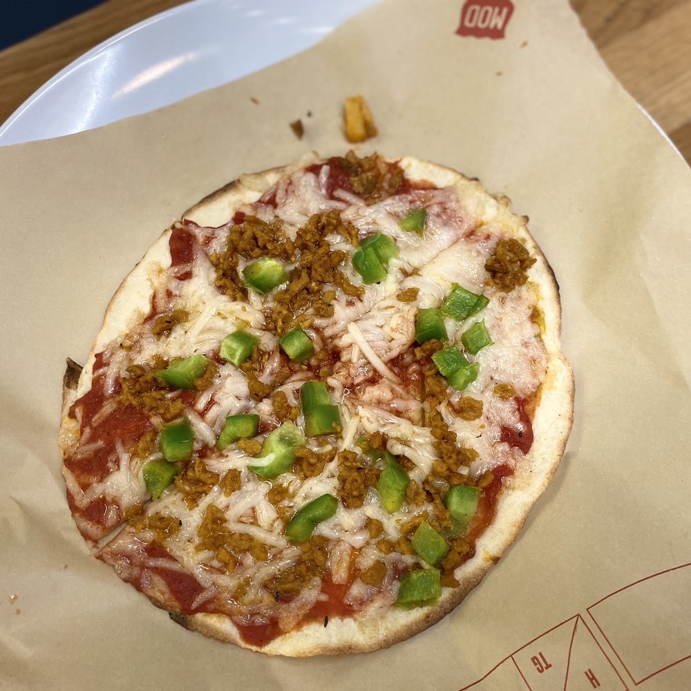 Non-dairy cheese and meat alternative crumbles with green peppers, mini pizza