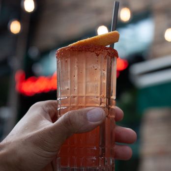 Mama Taco - a hand holding a glass with a drink in it - Mexican Near Me - New York, New York Mama Taco - a hand holding a glass with a drink in it - Mexican Near Me - New York, New York