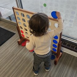 Busy Einstein Cognitive Play Center - Toddler playing giant Connect 4