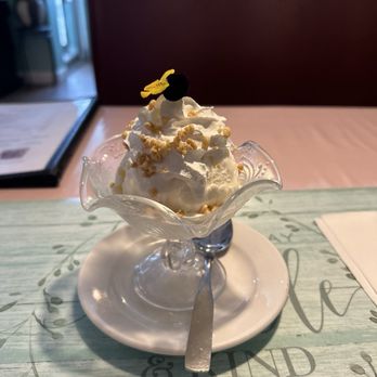 Nice Thai Cuisine - Coconut ice cream with sprinkling of peanuts on whipped cream cream - and a cute little fresh pansy - Thai Near Me - Chesapeake, Virginia
