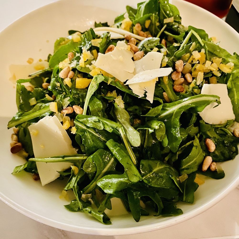 The West End - Arugula Salad with roasted pine nuts, preserved lemons, shaved parm, & EVOO - New American Near Me - Hyannis, Massachusetts The West End - Arugula Salad with roasted pine nuts, preserved lemons, shaved parm, & EVOO - New American Near Me - Hyannis, Massachusetts