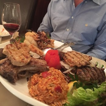 Restaurant Delphi - Mixed platter of lamb, pork, gyro, calamari, fish and kafka served with a delicious tomato rice - Greek Near Me - Villach, 2