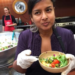 Photo of Martin de Porres House of Hospitality - San Francisco, CA, US. Nayomi making sure that salad is safe for the guests.