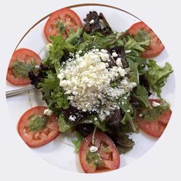 House salad. Spring greens, feta, tomato, and basil pesto vinaigrette. House salad. Spring greens, feta, tomato, and basil pesto vinaigrette.
