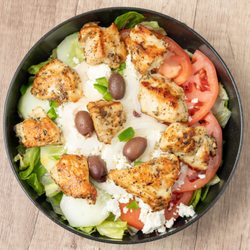 Santorini Grill - Santorini Salad - Fresh Greek salad topped with tender grilled chicken breast. Served with Greek dressing on the side.