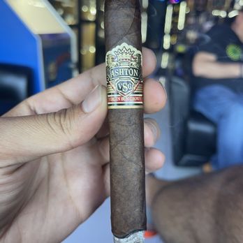 Xavier's Cigar Lounge - a hand holding a cigar - Cigar Bars Near Me - Hallandale Beach, Florida Xavier's Cigar Lounge - a hand holding a cigar - Cigar Bars Near Me - Hallandale Beach, Florida