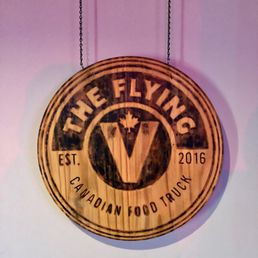a wooden sign hanging on a wall