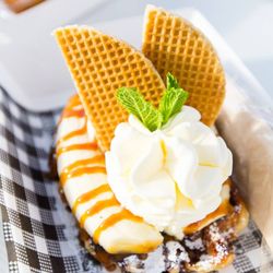 Crunchy's All-Day-Desserts Cafe & Double Decker Bus - The Flying Dutchman: Liège waffle topped with banana, crème brûlée ice cream, house-made caramel, whipped cream, finished with a stroopwafel