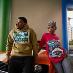 Oakland Don’t Play - Models wearing Oakland Don't PlAY Welcome to Oakland Hoodie and 5.0 racing t shirt
