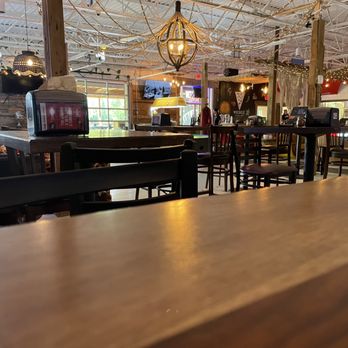 Wedge Pizza and Pub - a wooden table and chairs - Pizza Near Me - Nashville, Tennessee Wedge Pizza and Pub - a wooden table and chairs - Pizza Near Me - Nashville, Tennessee