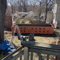 GO4 Junk Removal - Dumpster used to take away brick and cement debris from garage demolition.